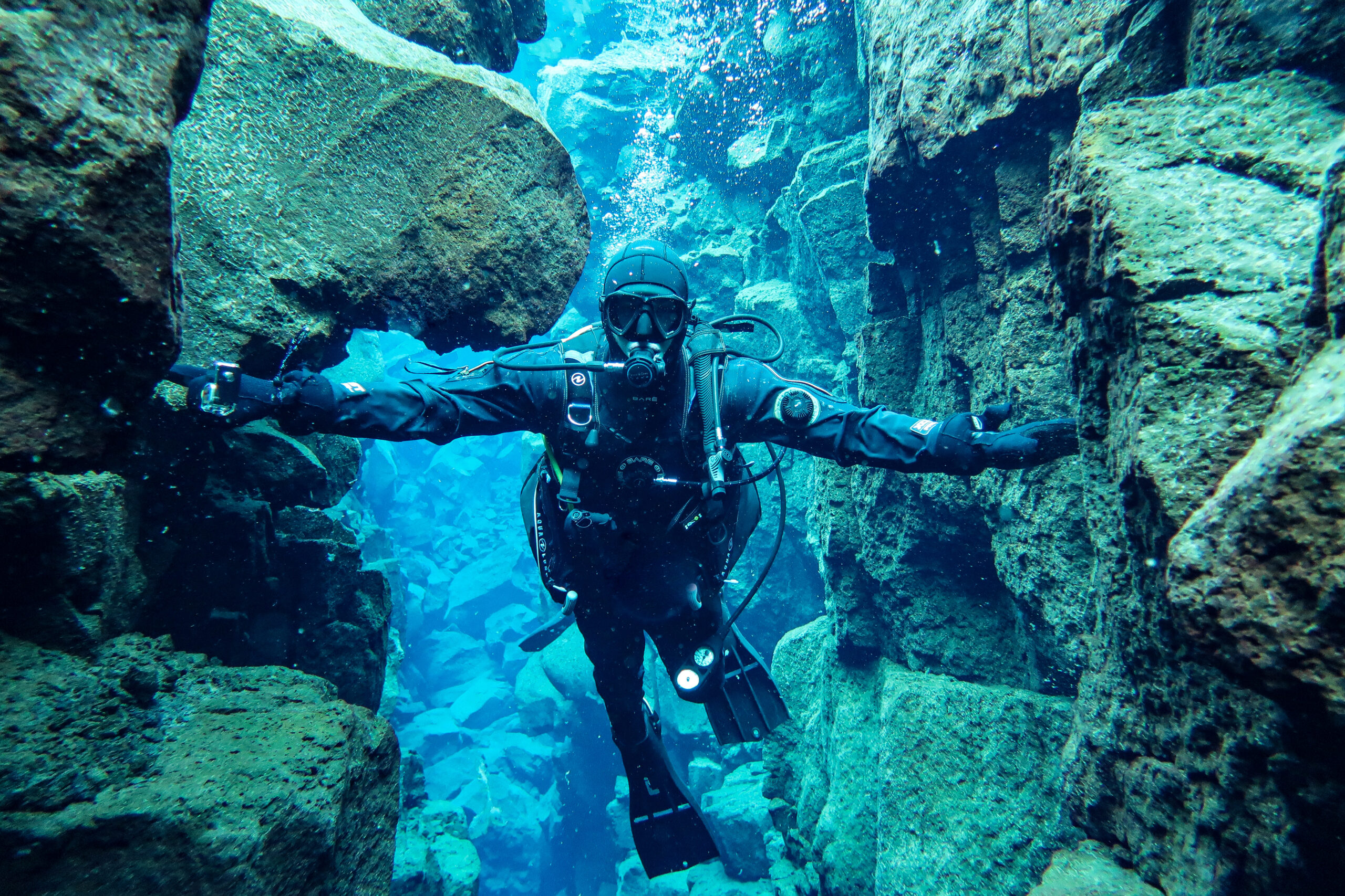 Scuba diver between tectonic plates at Silfra in Iceland